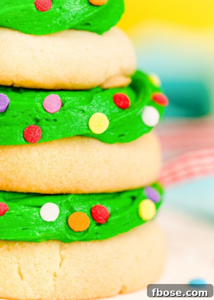 Festive Fir Tree Treats 3 Close up photo of beautifully stacked sugar cookies with vibrant green icing, expertly arranged to form a delightful Christmas tree shape.