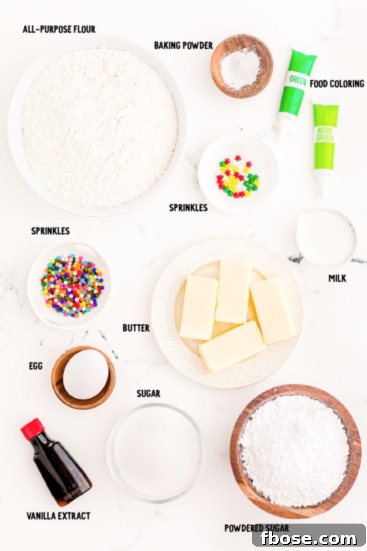 Festive Fir Tree Treats 4 Overhead photo showing a beautifully arranged collection of ingredients, prepped and ready to be used for making Christmas tree cookie stacks, all on a pristine white marble surface.