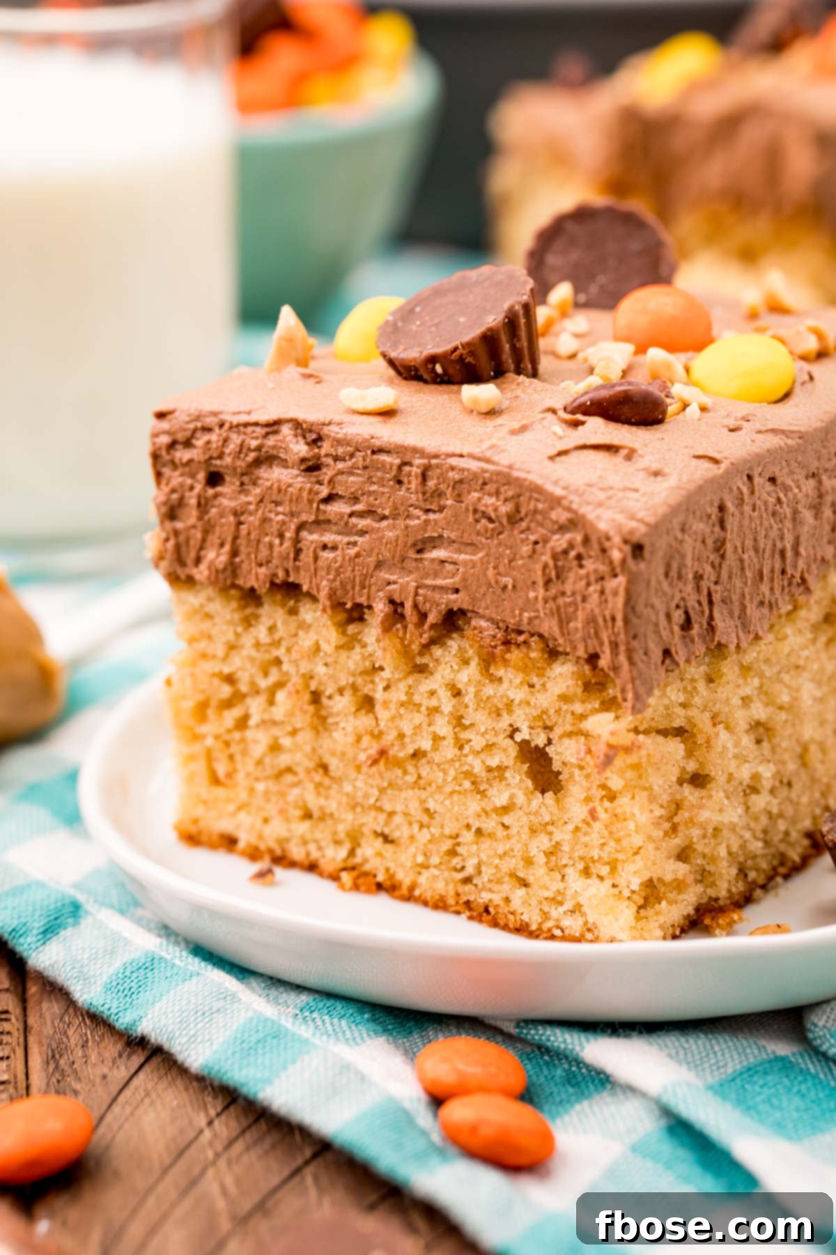 Ultimate Peanut Butter Sheet Cake 3 Slice of peanut butter sheet cake on a white plate.