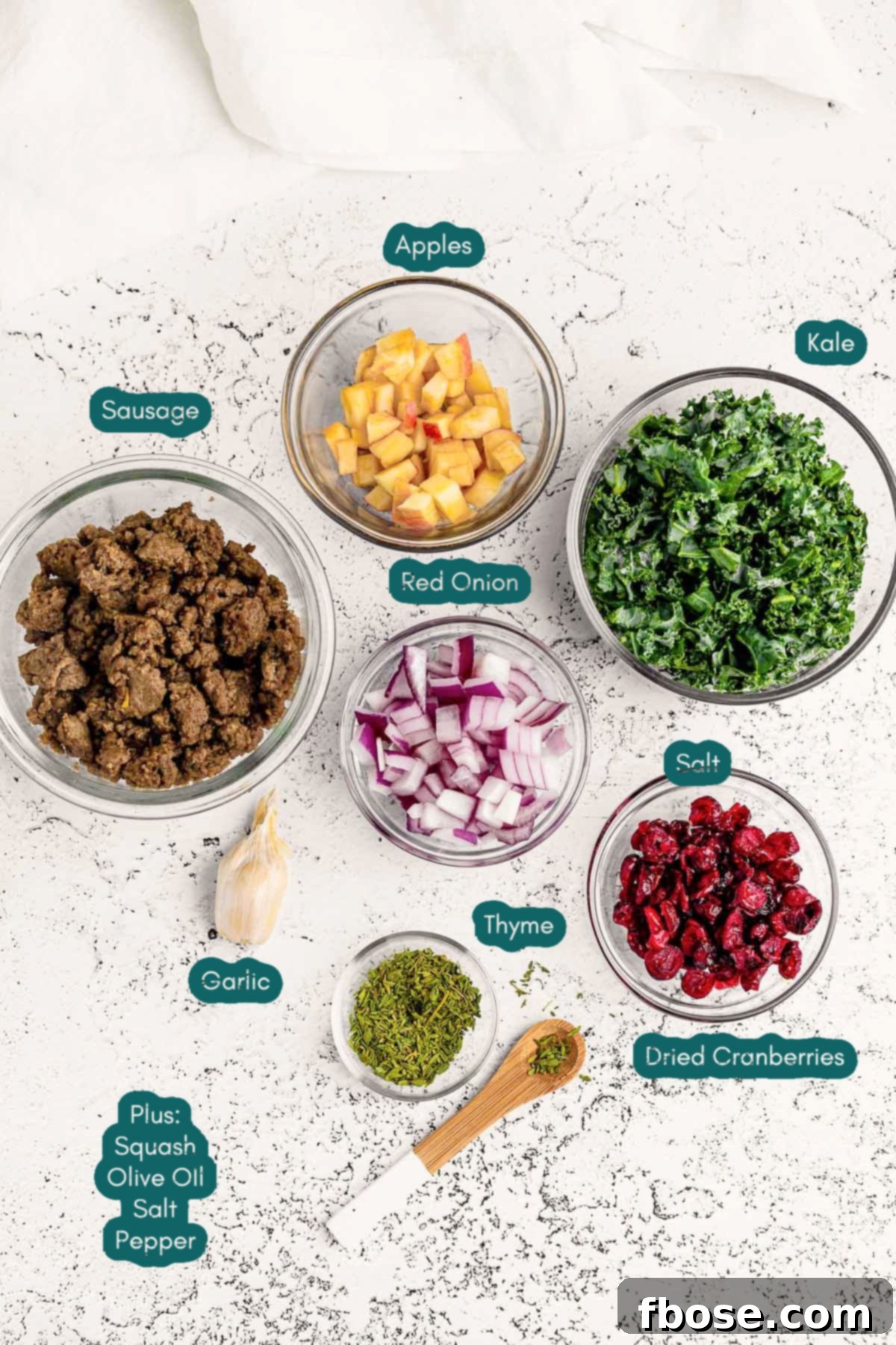 Ingredients to make stuffed acorn squash prepared on a marble surface.
