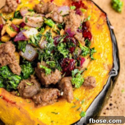 Close up photo of stuffed acorn squash on parchment paper.