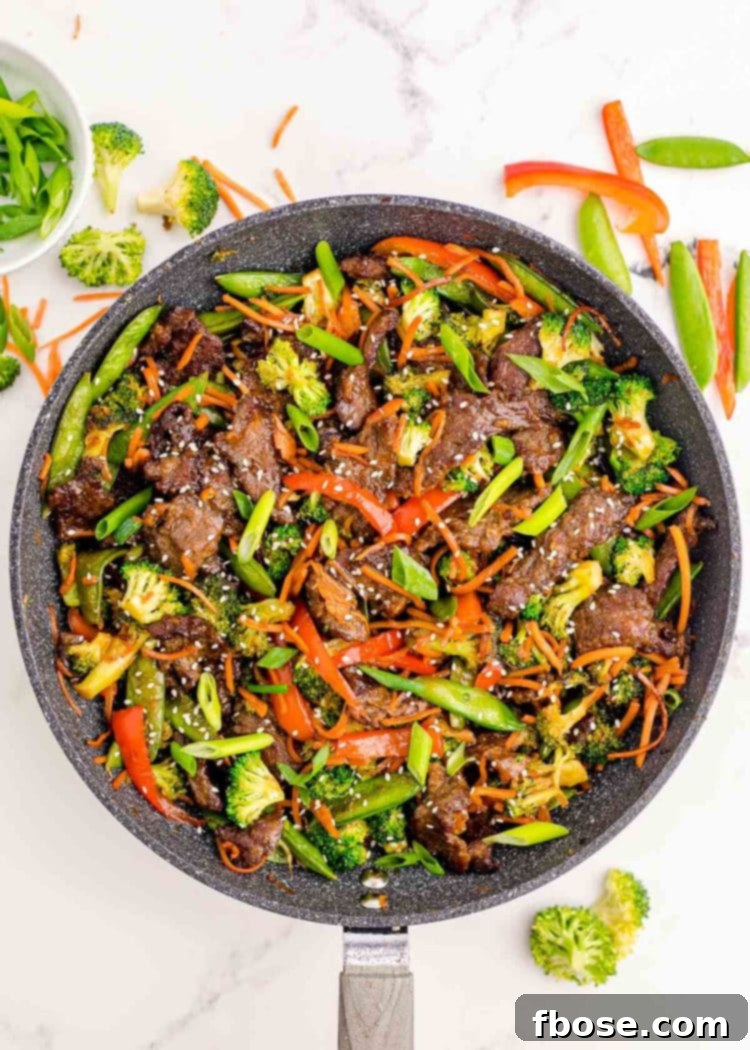 Overhead photo of beef stir fry in a skillet.