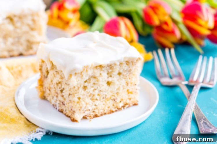 A slice of the Best Banana Cake, showcasing its moist texture and rich cream cheese frosting.