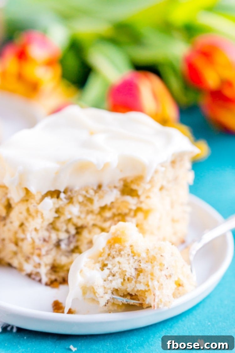 Close-up of the delicious banana cake with thick cream cheese frosting, ready to be served.