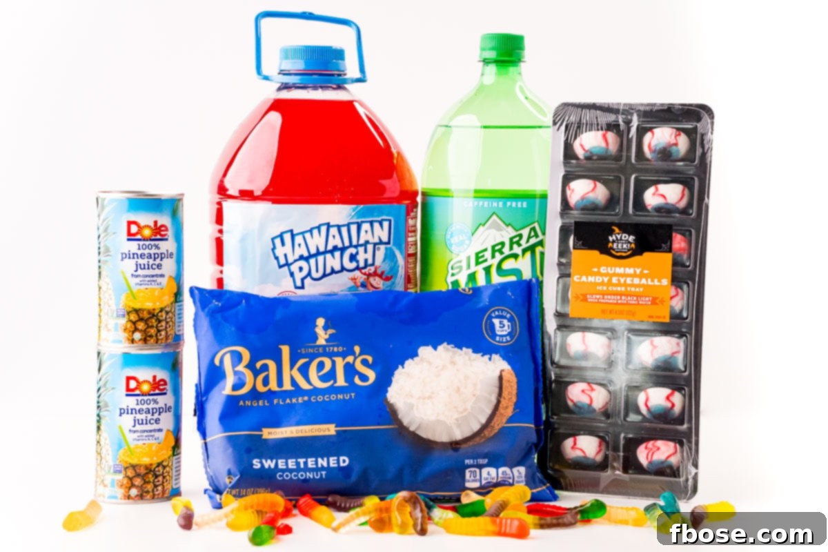 A vibrant flat lay photo showcasing all the ingredients required to make Werewolf Halloween punch on a clean white surface. Includes bottles of fruit punch, lemon-lime soda, pineapple juice, a bag of shredded coconut, gummy worms, and candy eyeballs.