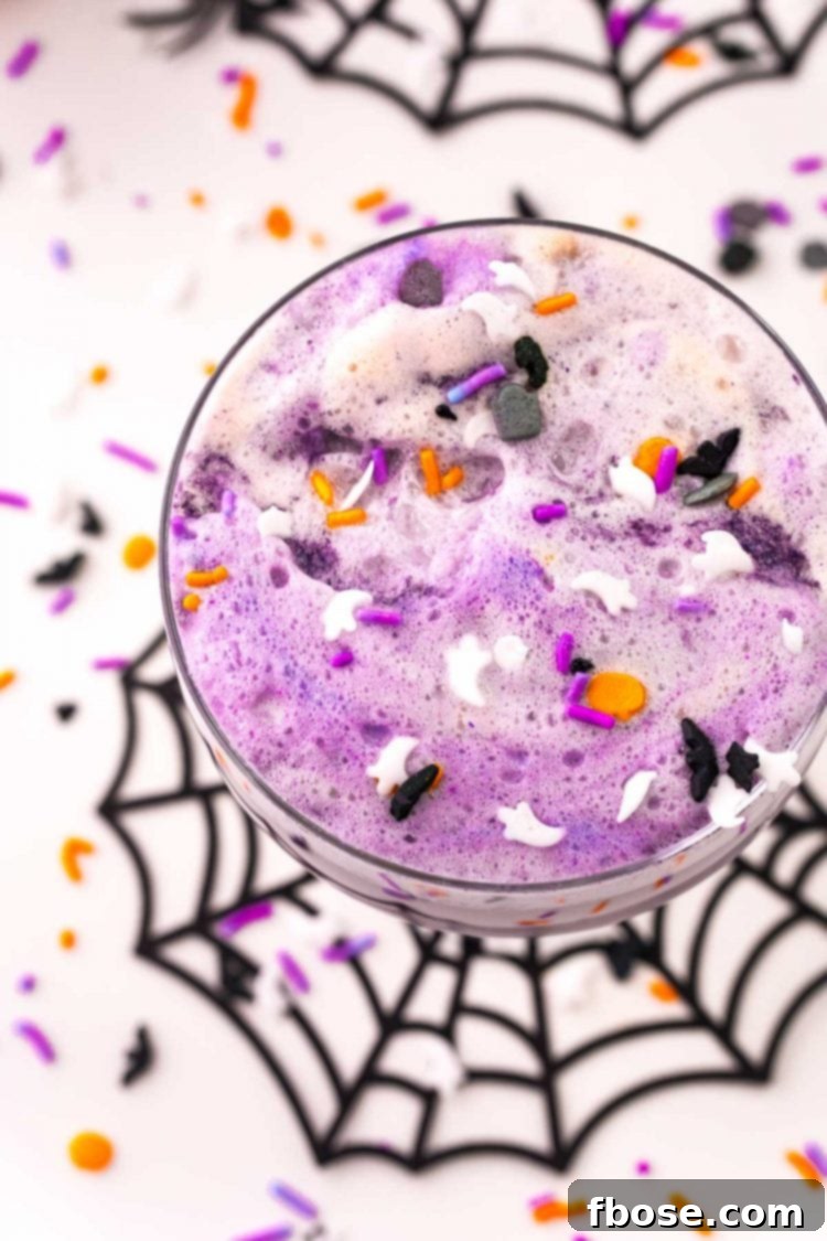 overhead photo of a glass of witch's brew Halloween party punch for kids.