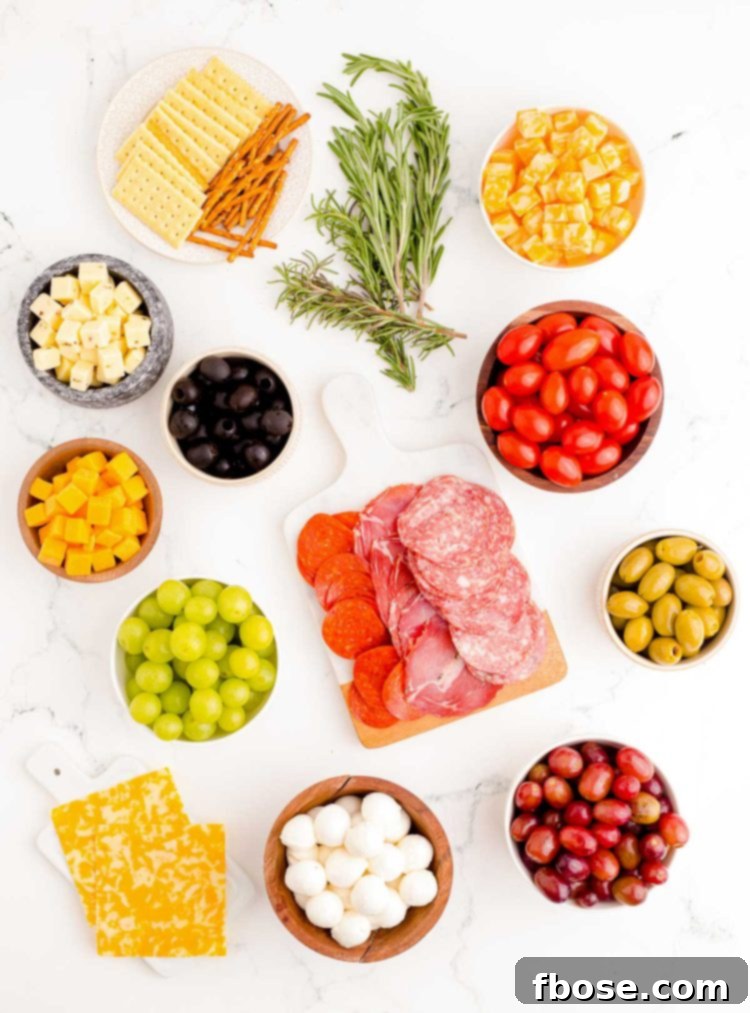 Overhead photo of ingredients used to make a Christmas Tree shaped charcuterie board.