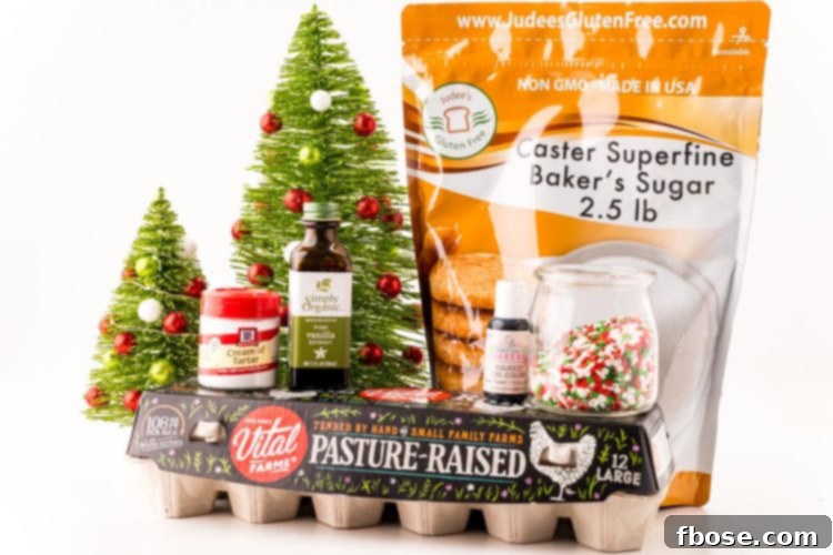 Ingredients to make christmas tree meringue cookies on a white table.