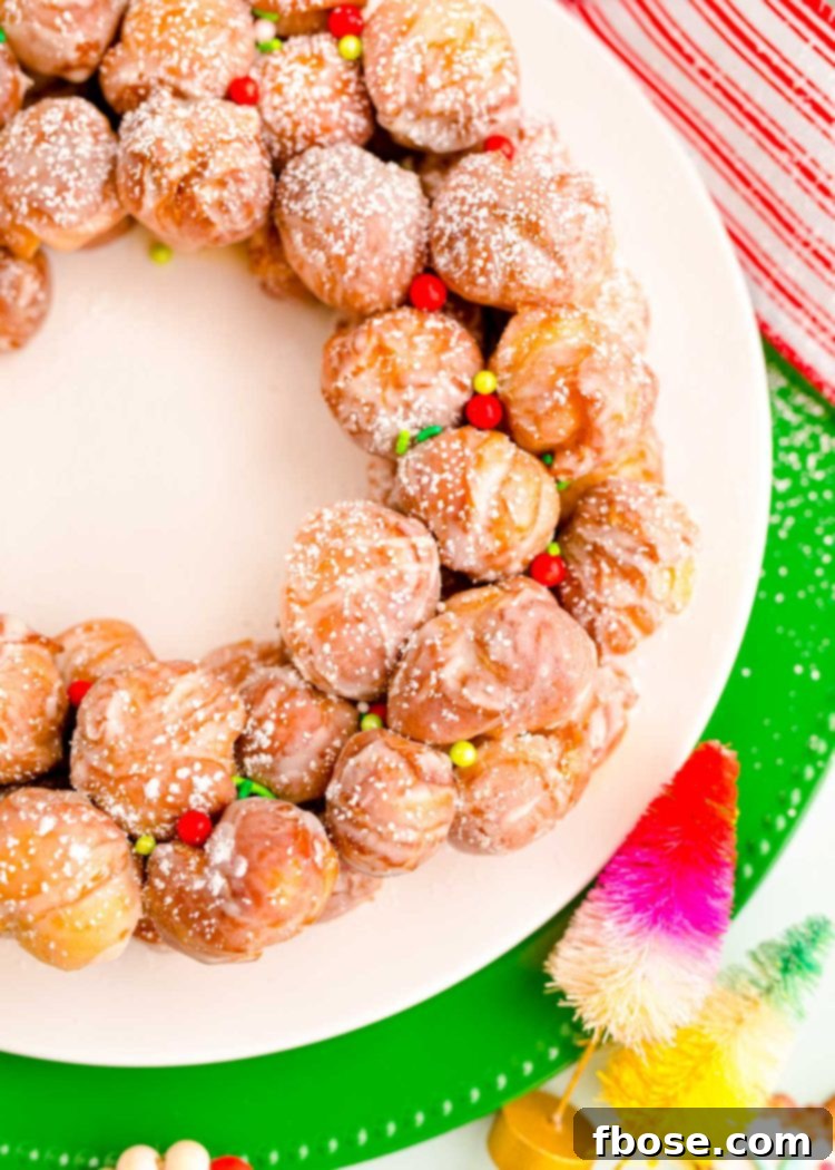 Festive Doughnut Drop Wreath 3 Close up photo of donut holes on a plate with holiday sprinkles.