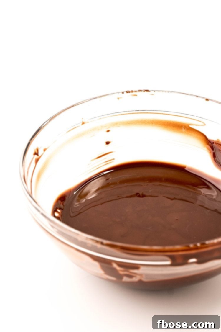 Melted chocolate in a glass bowl.