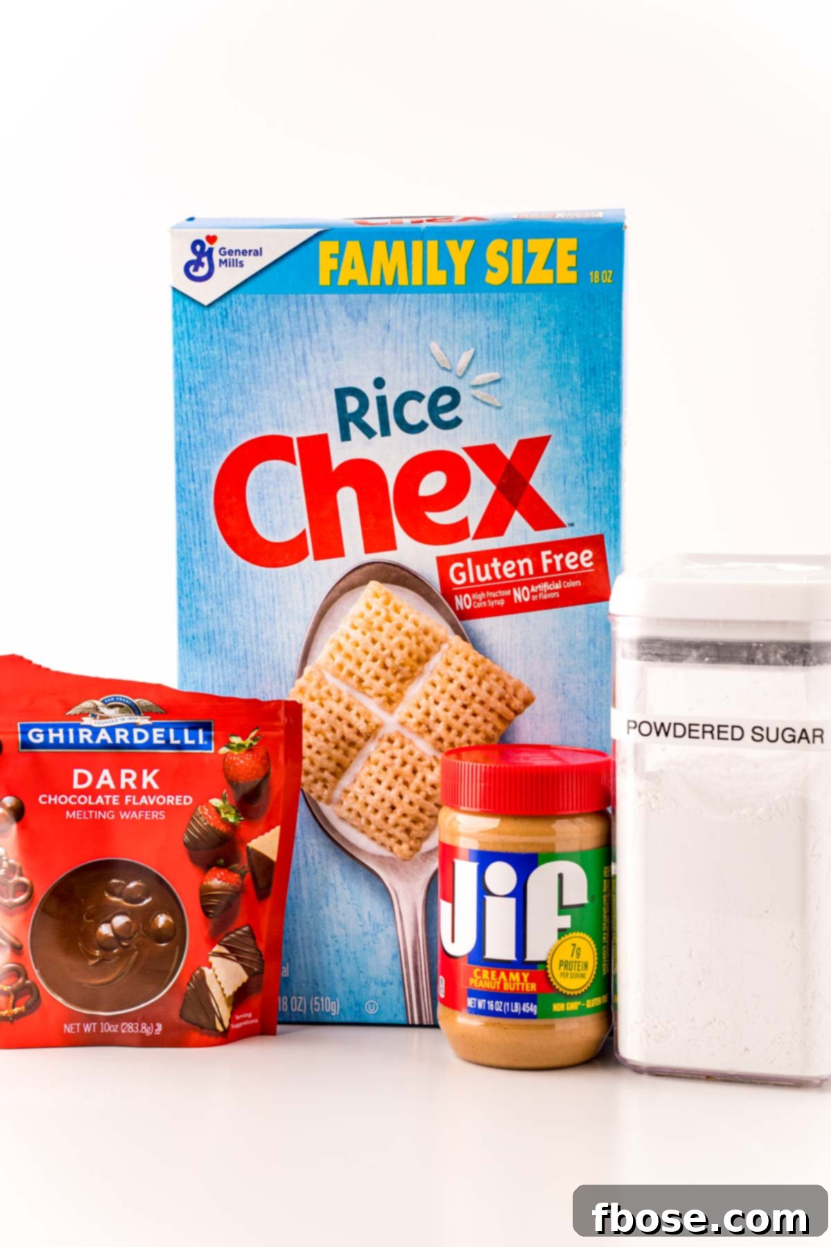 Ingredients to make Puppy Chow Truffles on a white counter.