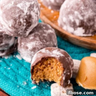 Close up photo of puppy chow truffles on a teal woven placemat with muddy buddies around them.