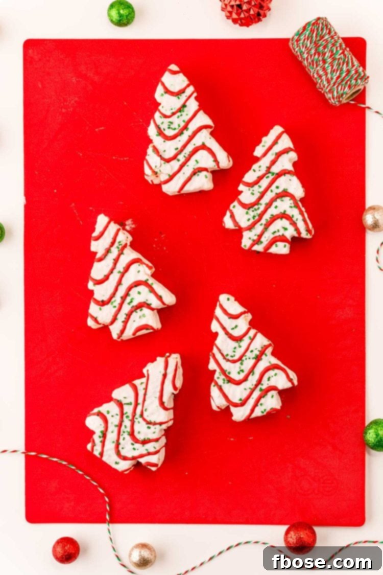 Overhead photo of Little Debbie Christmas Tree Cakes arranged neatly on a red cutting board, ready for preparation.