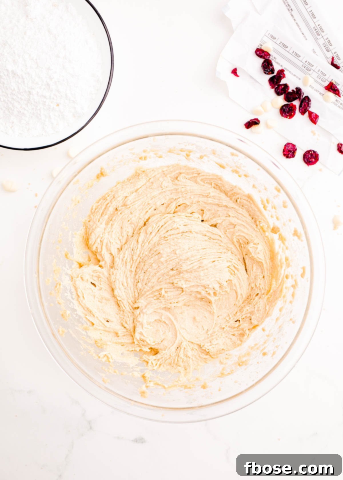 Overhead photo of a glass mixing bowl containing the initial blondie batter mixture, smooth and ready for dry ingredients.