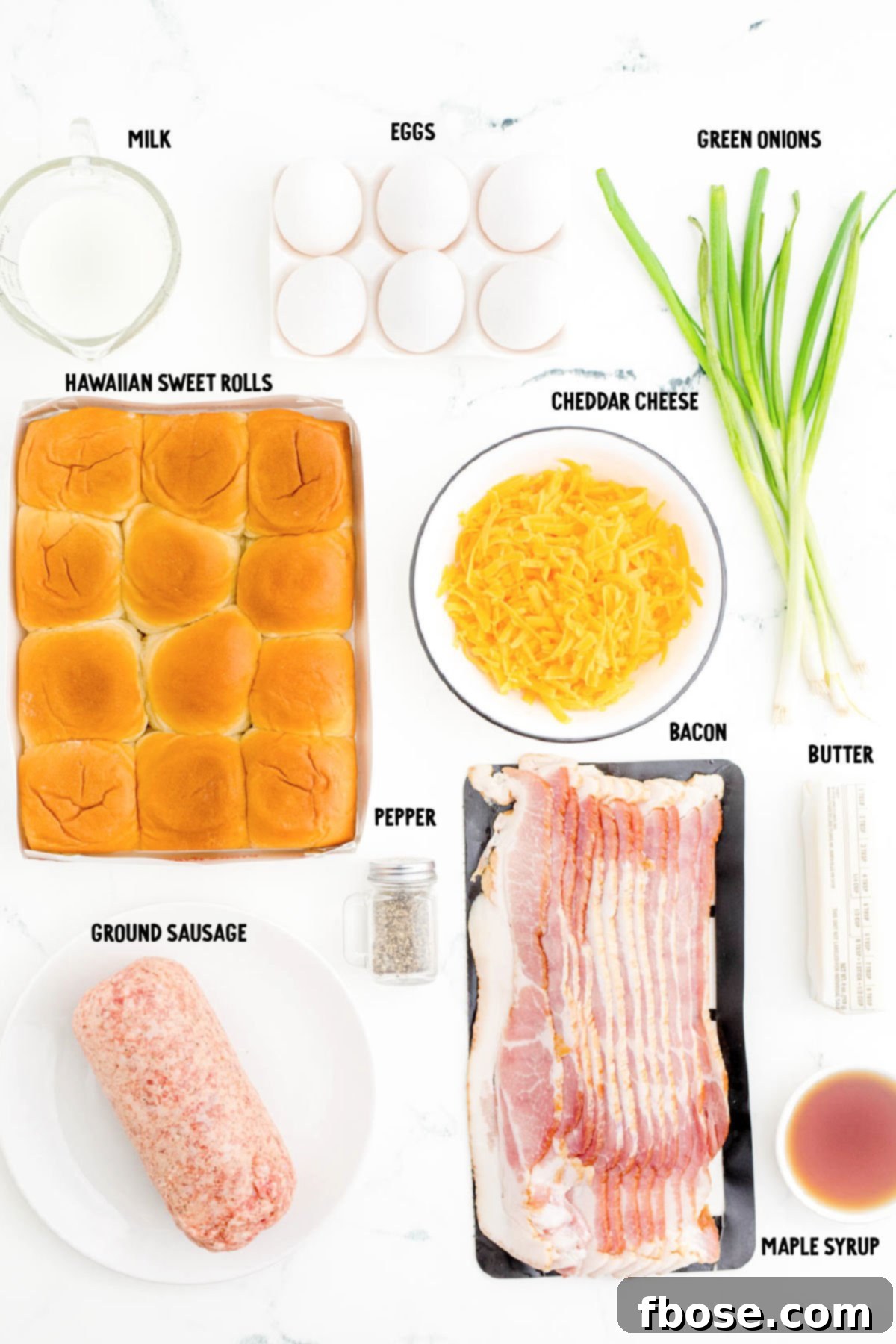 Overhead photo of ingredients to make breakfast sliders on a marble surface.