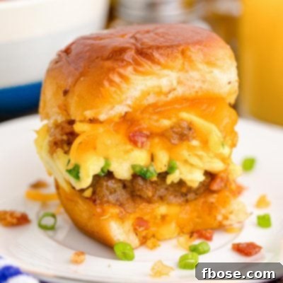 Close up photo of breakfast sliders on a white plate on a blue and white striped napkin.