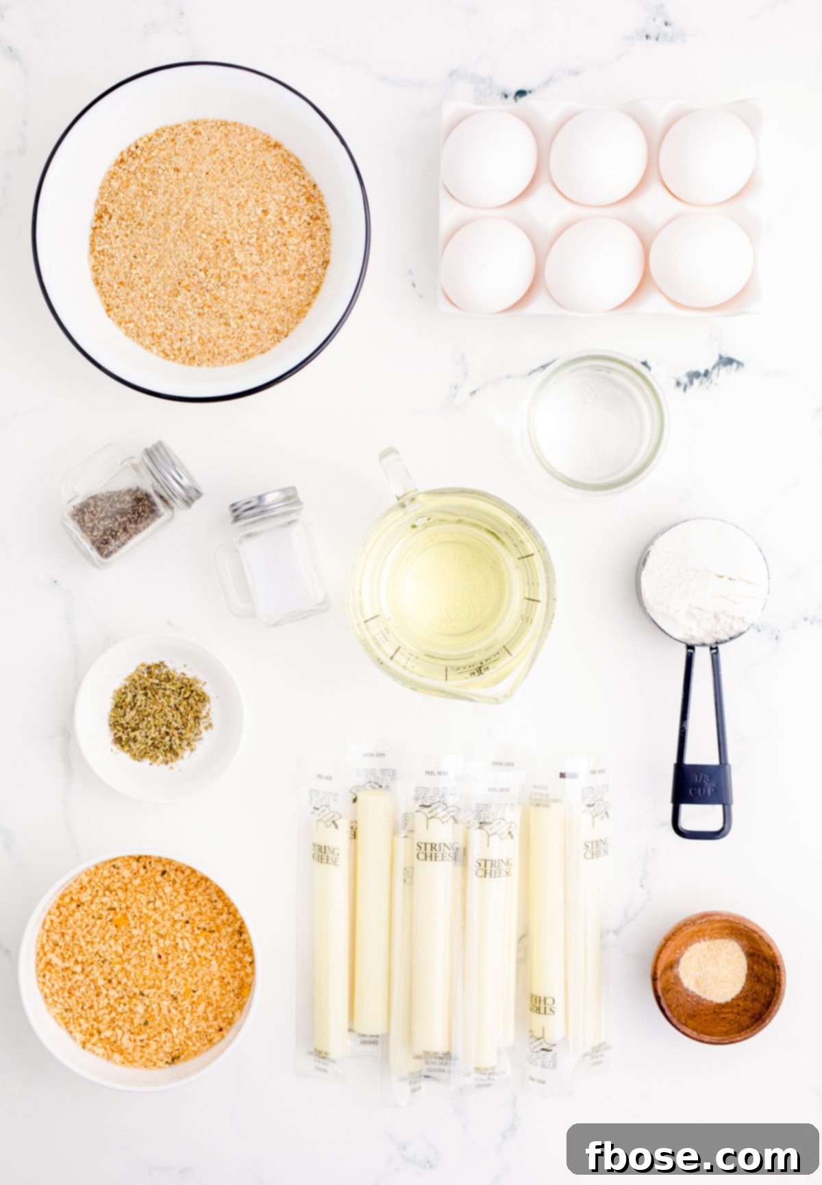 Overhead photo of Mozzarella Stick Ingredients on a marble surface.
