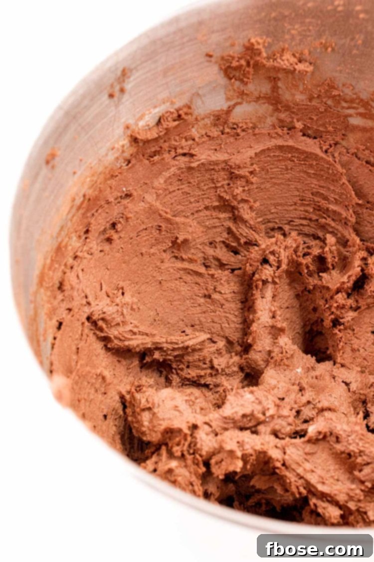 Mint Chocolate Thumbprint Treasures 5 Chocolate cookie dough mixed in a stand mixer bowl.