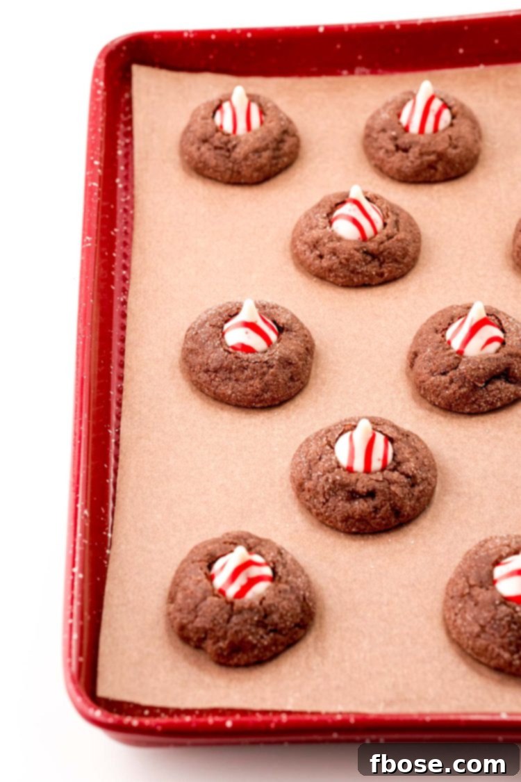 Mint Chocolate Thumbprint Treasures 7 Chocolate thumbprint cookies with peppermint kisses on top.