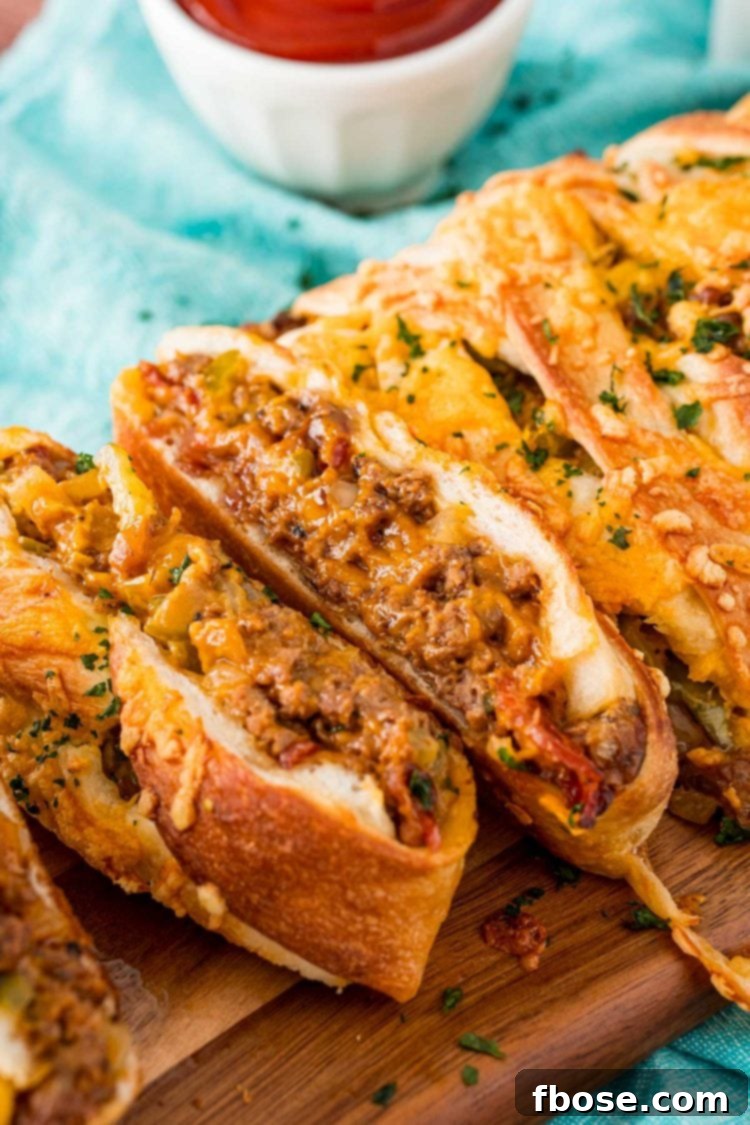 Easy Loaded Bread 3 Garbage bread that's been sliced up on a wooden cutting board.