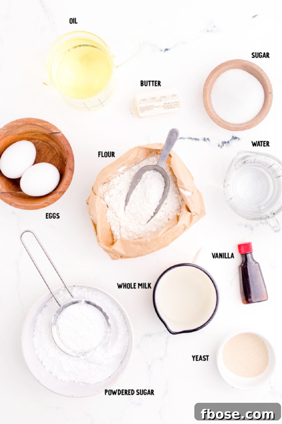Ingredients to make beignets on a marble counter.