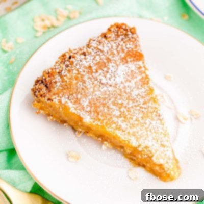 Close up photo of a slice of Milk Bar Pie on a white plate on a green napkin.