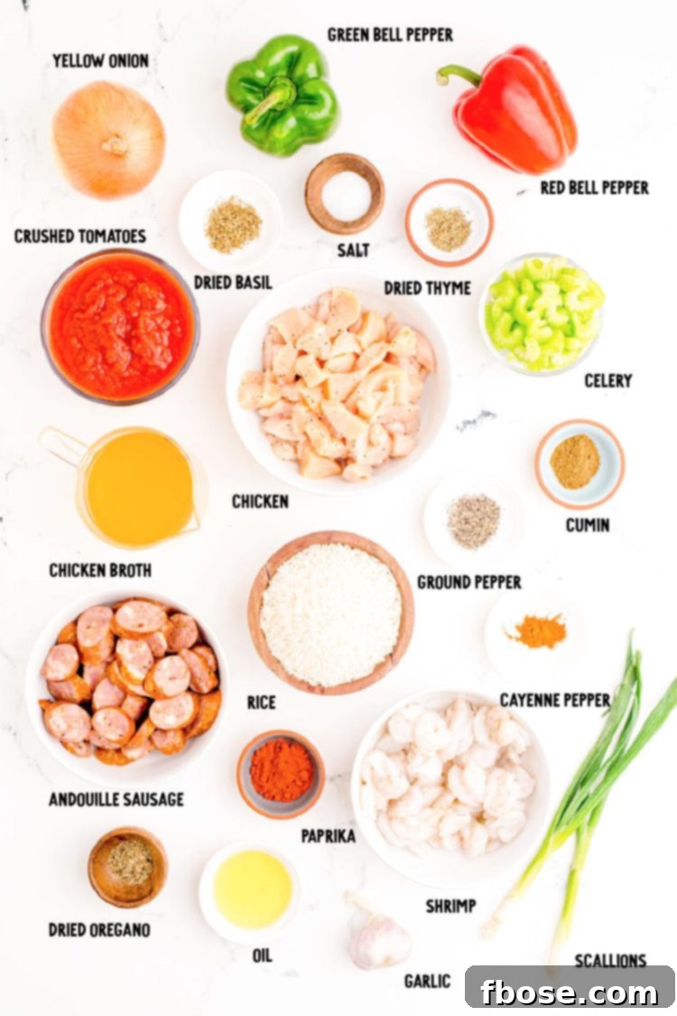 Ingredients to make jambalaya prepped on a marble countertop.