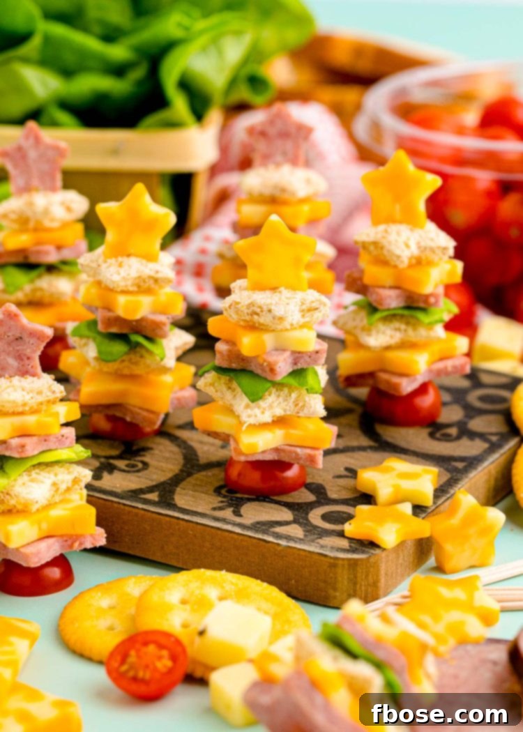 Easy Christmas tree shaped appetizers beautifully arranged on a rustic wooden cutting board, ready for serving at a holiday gathering.