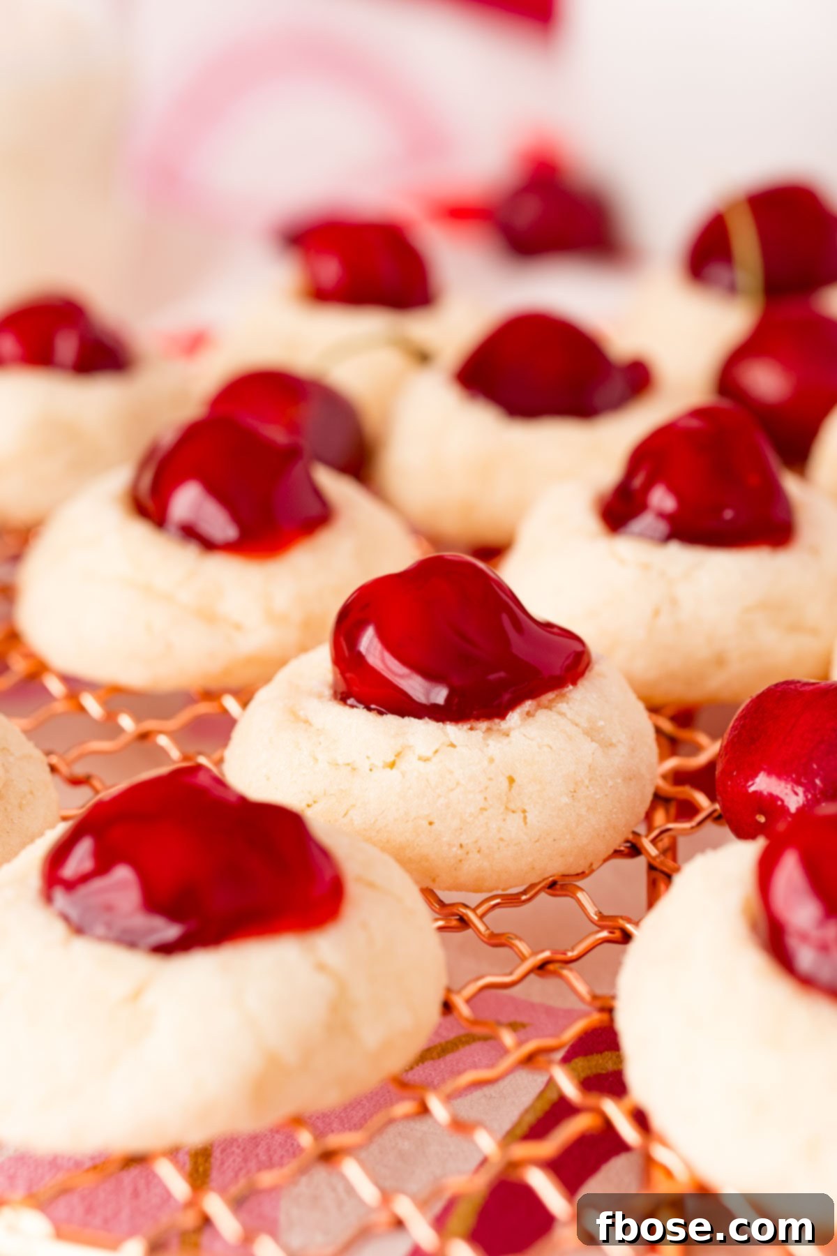 Close-up photo of delicious cherry cheesecake cookies, showcasing their tender texture and vibrant cherry topping.