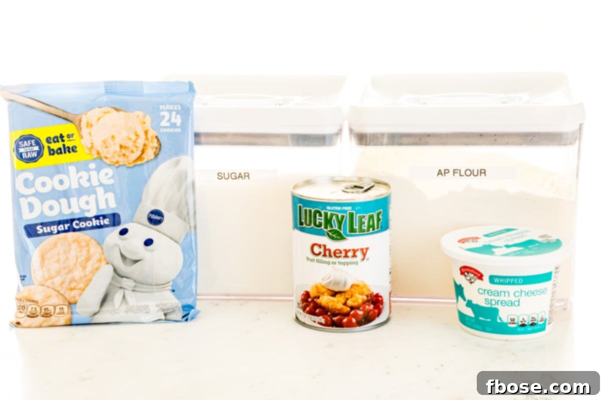 A flat lay photo showing all the ingredients neatly arranged for making Cherry Cheesecake Cookies.