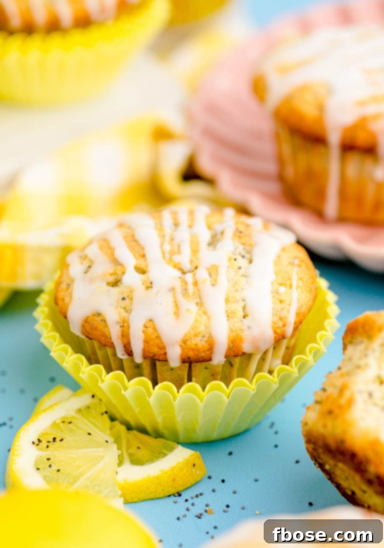 Lemon poppyseed muffins on a blue table.