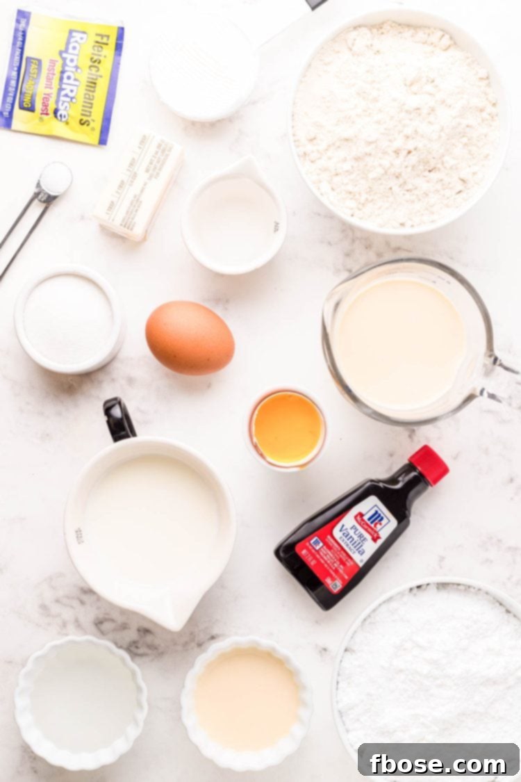 Ingredients to make yeast donuts from scratch on a marble counter.