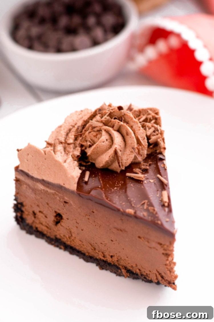 Decadent Instant Pot Chocolate Cheesecake 3 A slice of chocolate instant pot cheesecake on a white plate.