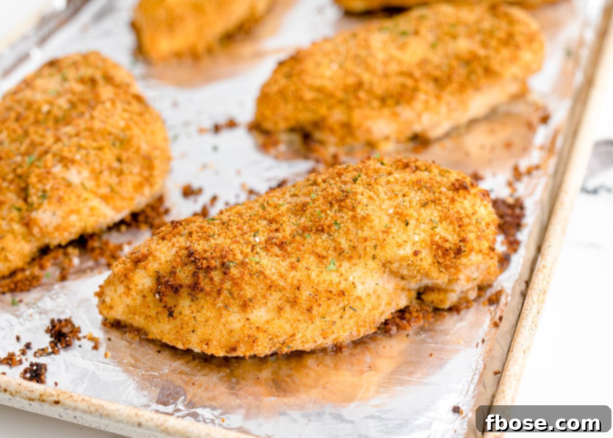 Shake and bake chicken made from scratch on an aluminum lined baking sheet.
