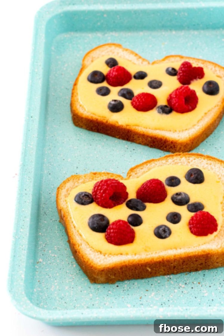 Yogurt Custard Toast 6 Two slices of yogurt toast ready to be baked on a blue baking sheet.