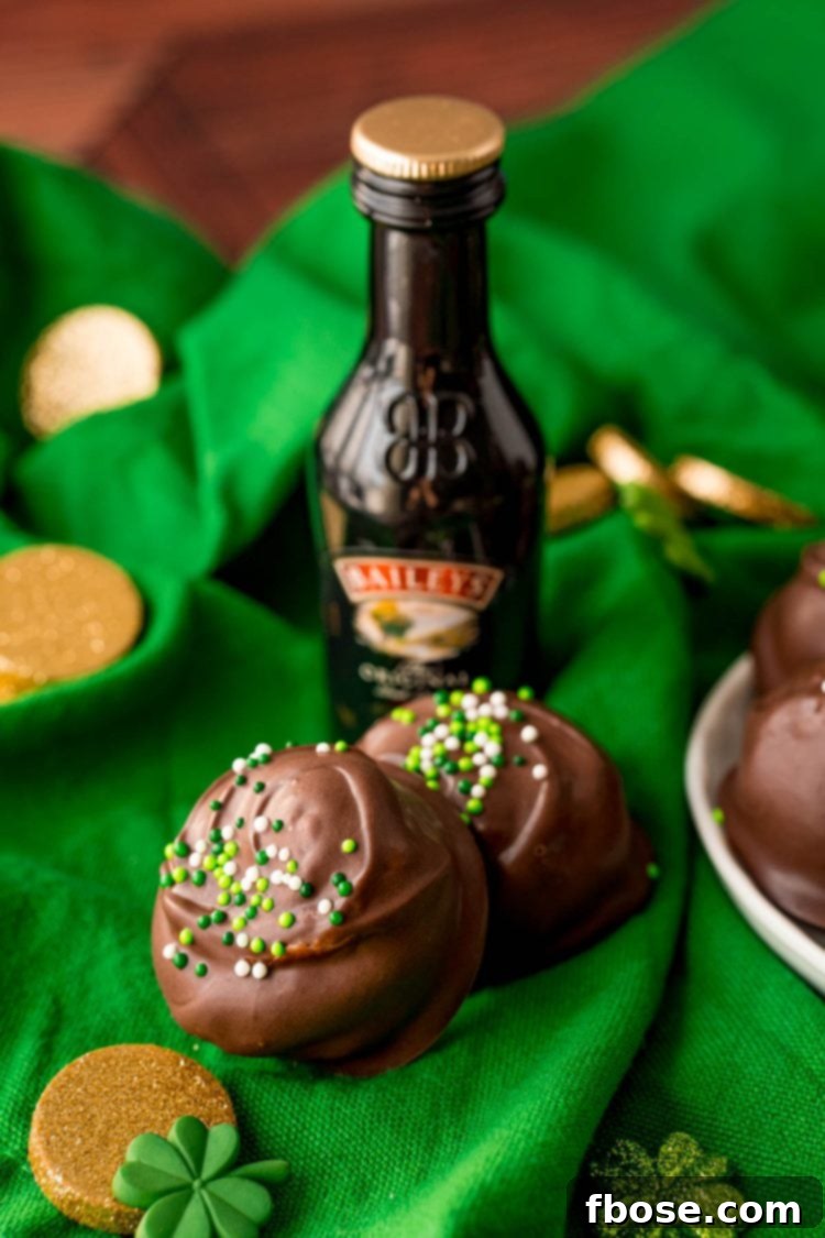 Two Bailey's Irish Cream truffles on a green napkin.