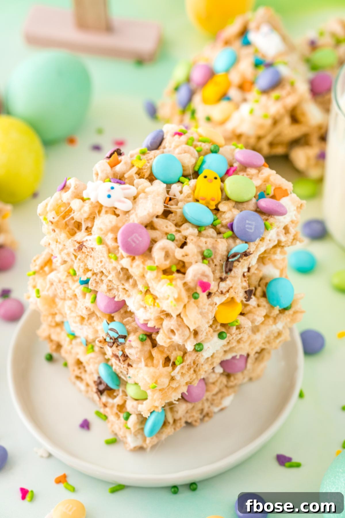 Close up photo of a stack of three Easter rice krispie treats on a small white plate.