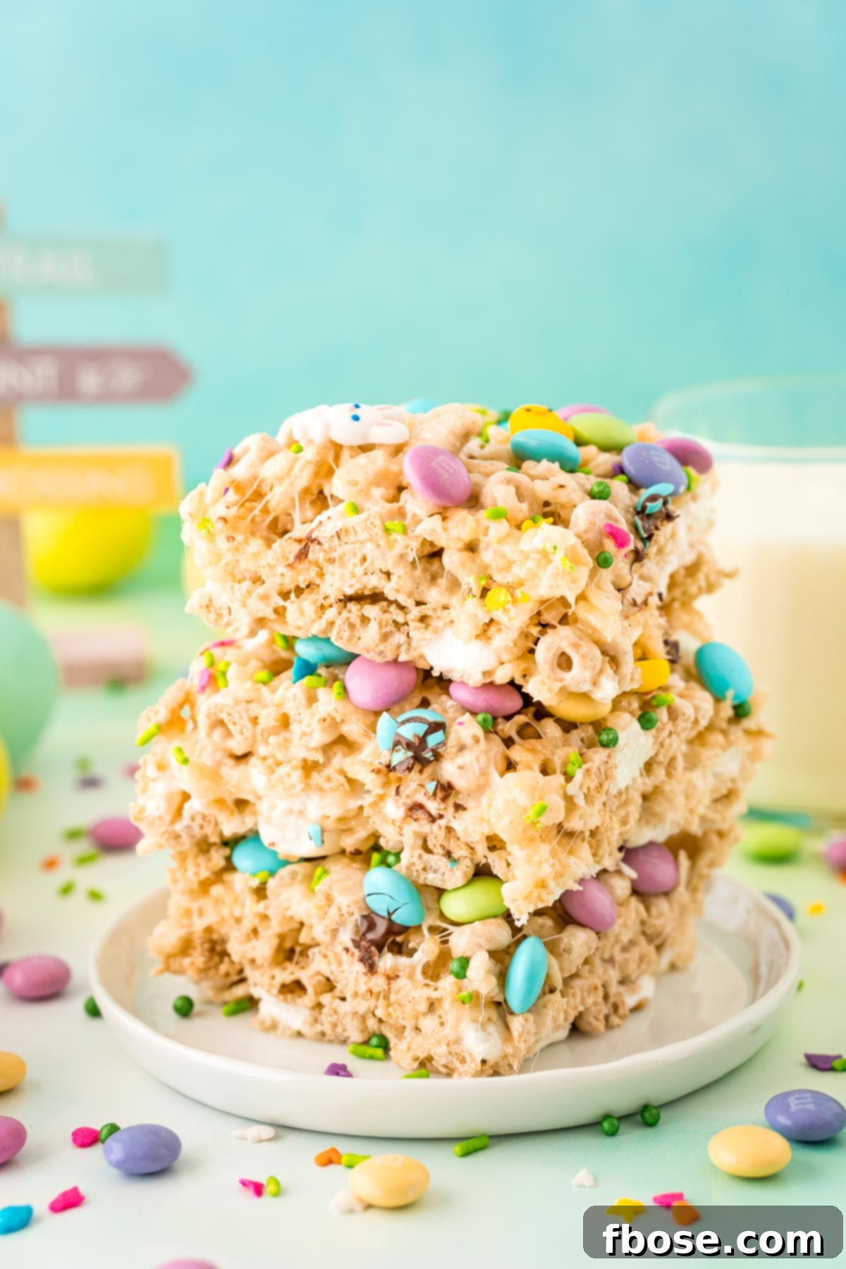 Close up photo of a stack of three Easter rice krispie treats on a white plate.