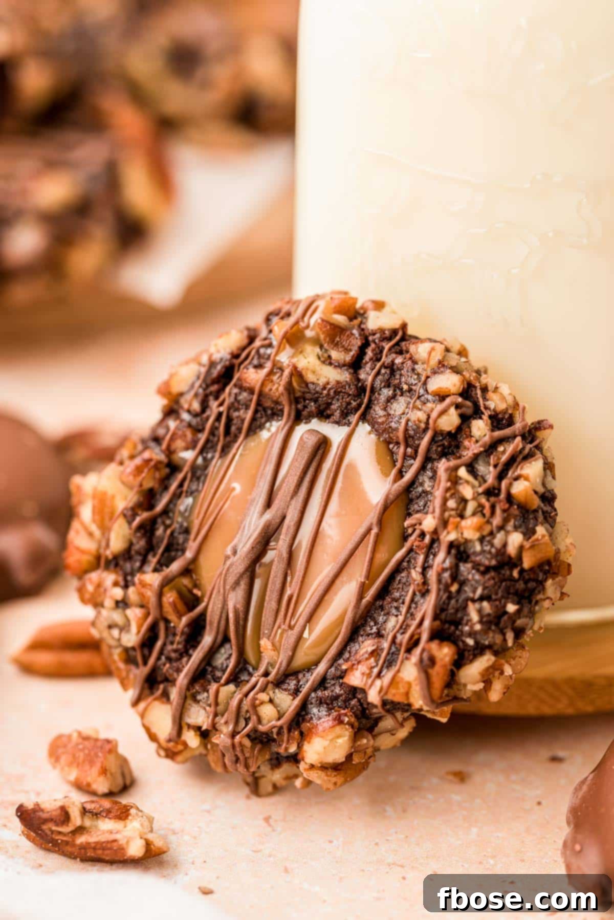 Decadent Turtle Thumbprint Delights 6 A turtle thumbprint cookie leaning against a bottle of milk.