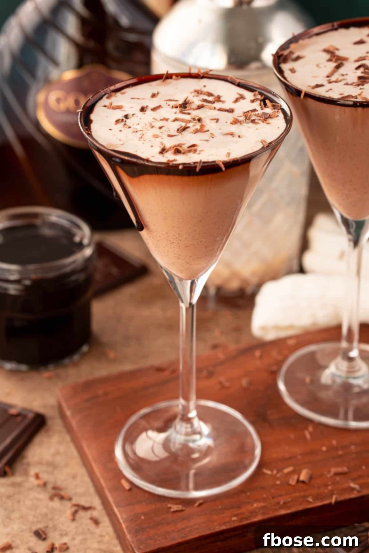 Close up photo of a chocolate martini on a wooden serving board.
