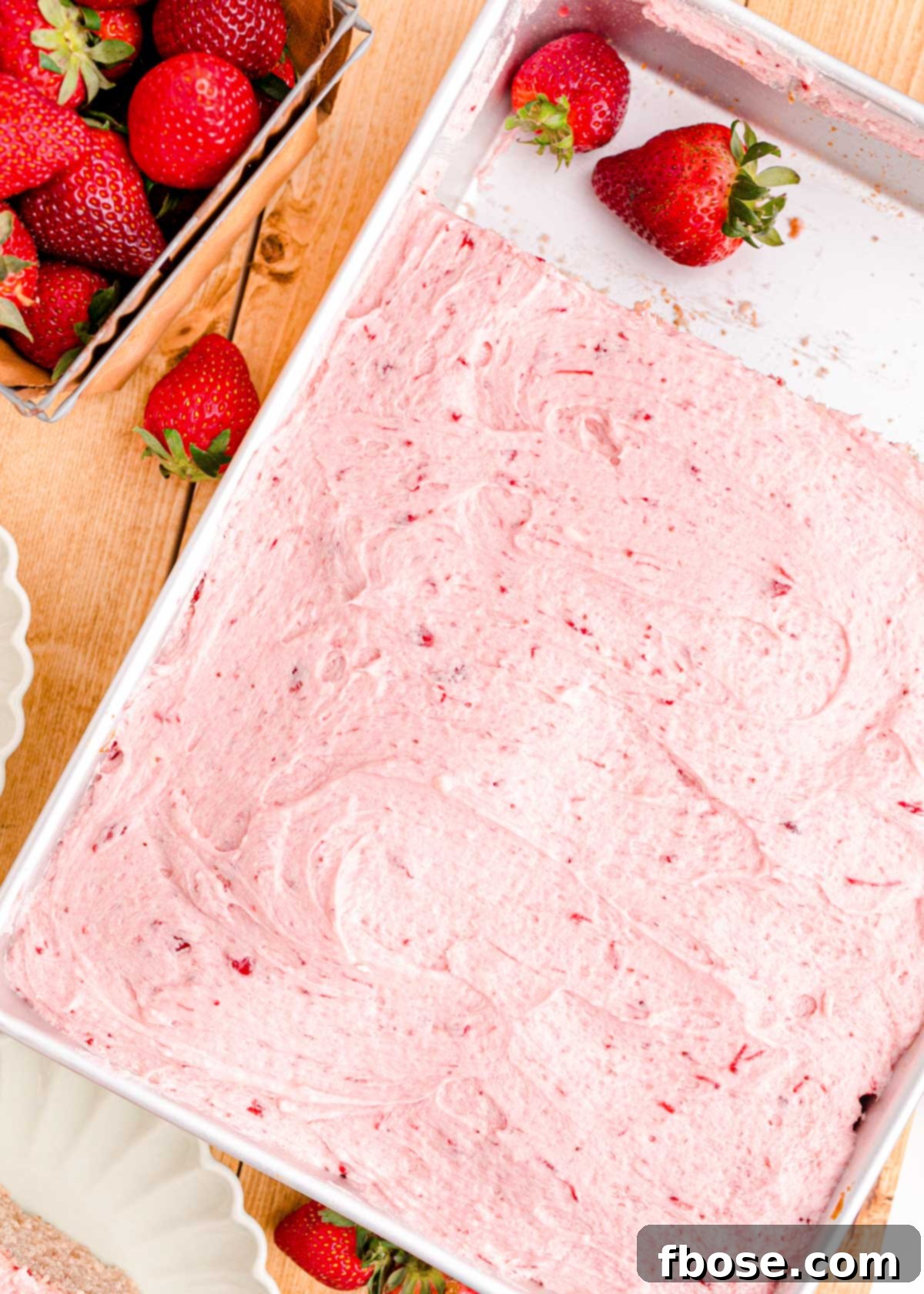 Strawberry sheet cake in a baking pan.