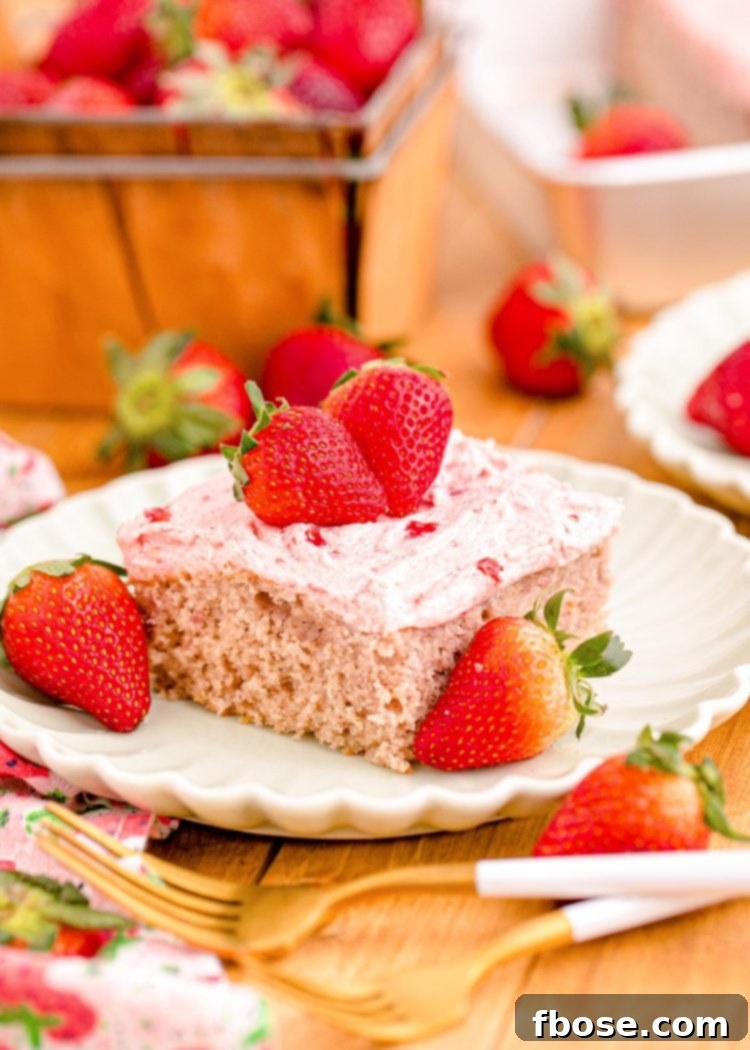 Close up photo of a slice of strawberry sheet cake on a plate.