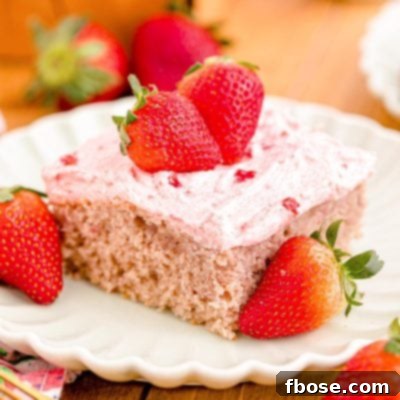 Close up photo of a slice of strawberry sheet cake on a plate.