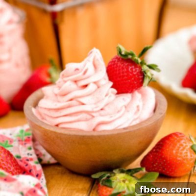 Strawberry buttercream frosting in a wooden bowl.