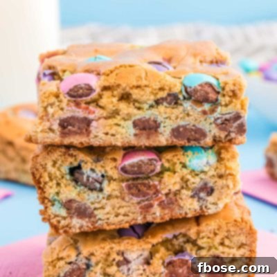 Close up of three easter blondie bars stacked on a pink napkin.