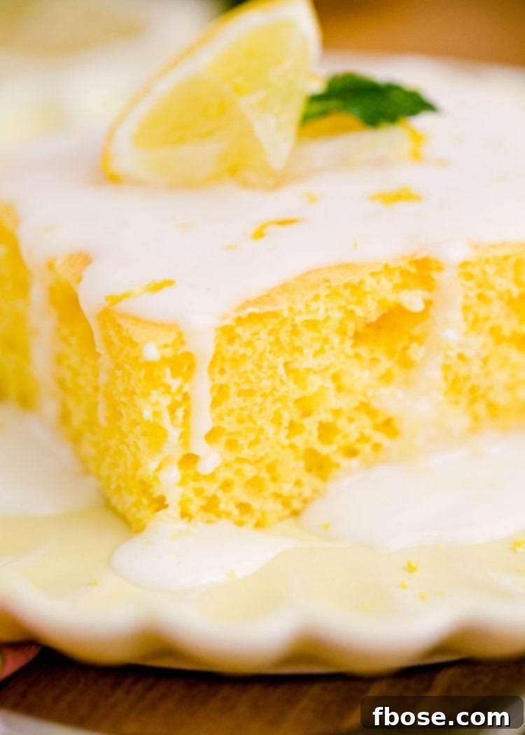Close-up photo of a vibrant slice of lemon Texas cake served on a bright yellow plate, highlighting its moist texture and rich glaze.