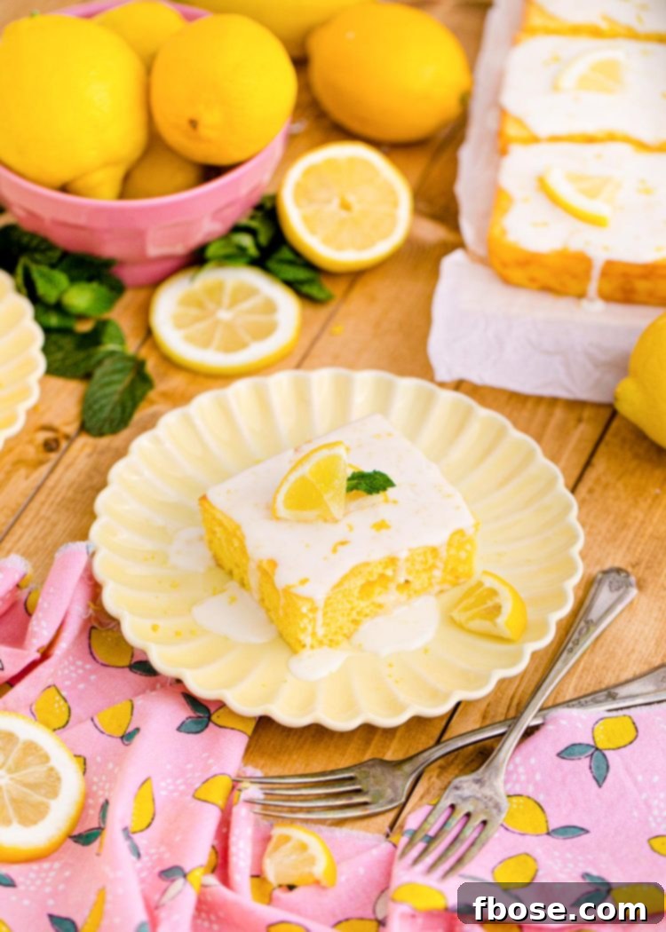 A square slice of delectable lemon sheet cake presented on a charming pink napkin, resting on a rustic wooden table.