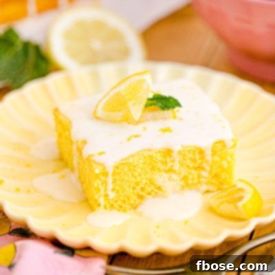 Close up photo of a slice of lemon sheet cake on a yellow plate.