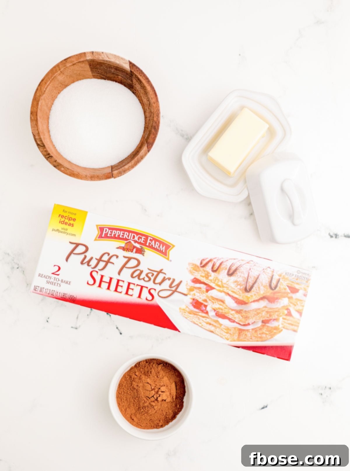 Ingredients to make homemade cruffins on a marble surface.