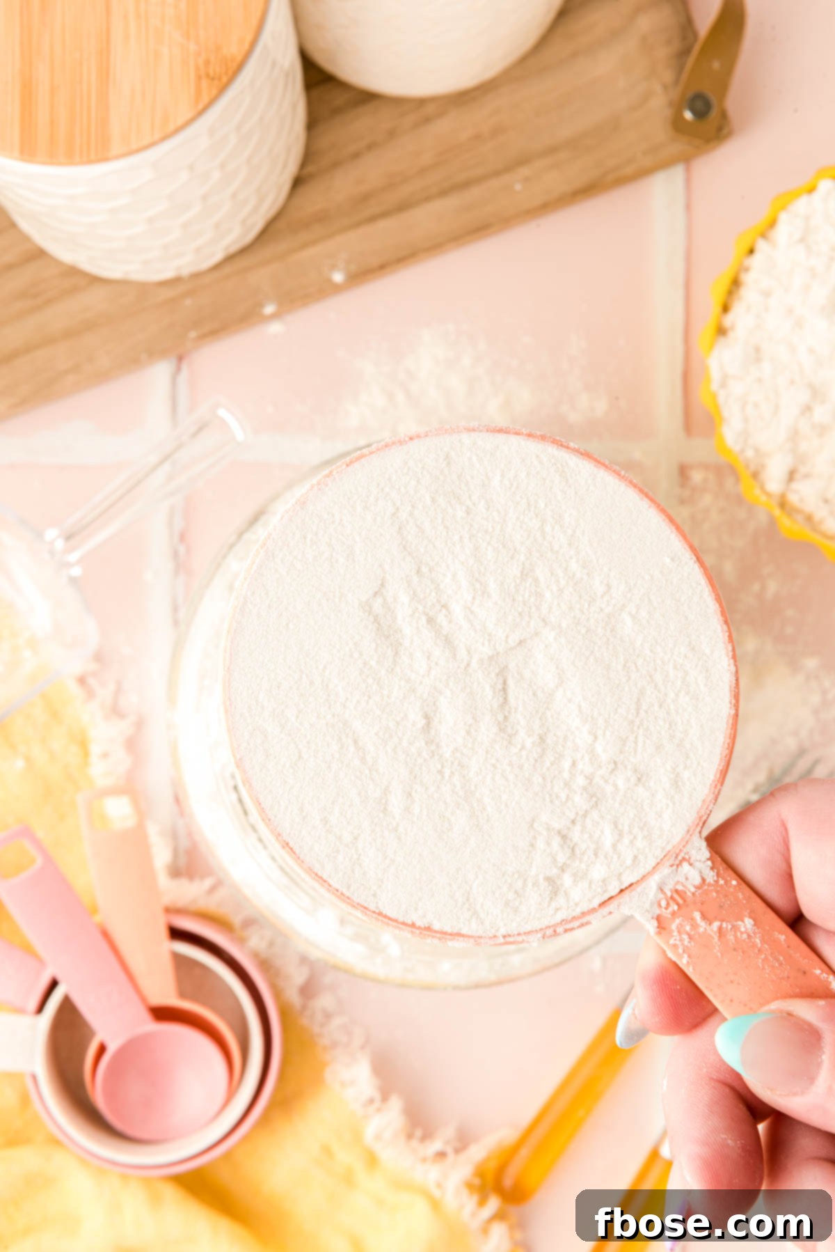 Overhead photo of a measuring cup with perfectly leveled flour in it, ready for use.